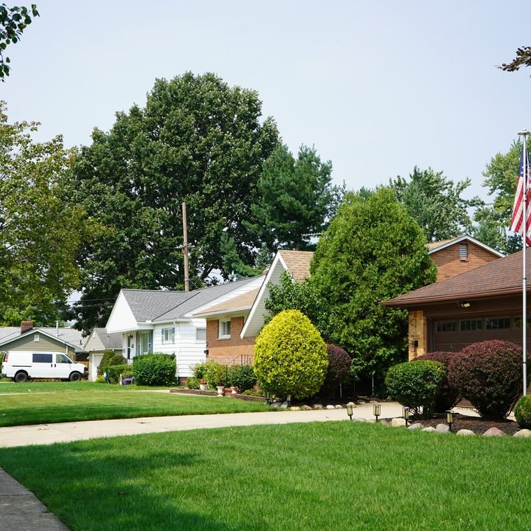 A Mayfield Heights residential street of homes with an American flag flying
