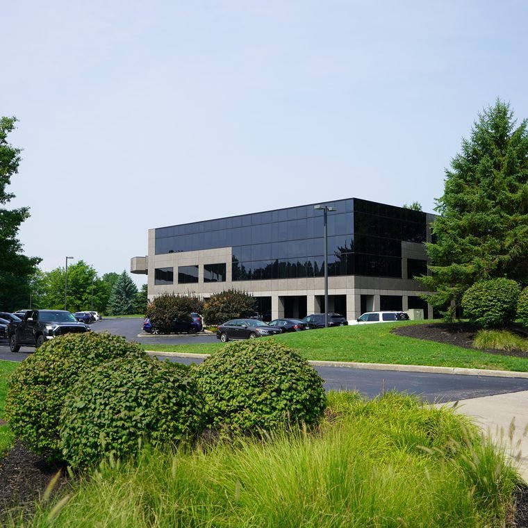 A glass-front executive office building in the Parkland Blvd office park