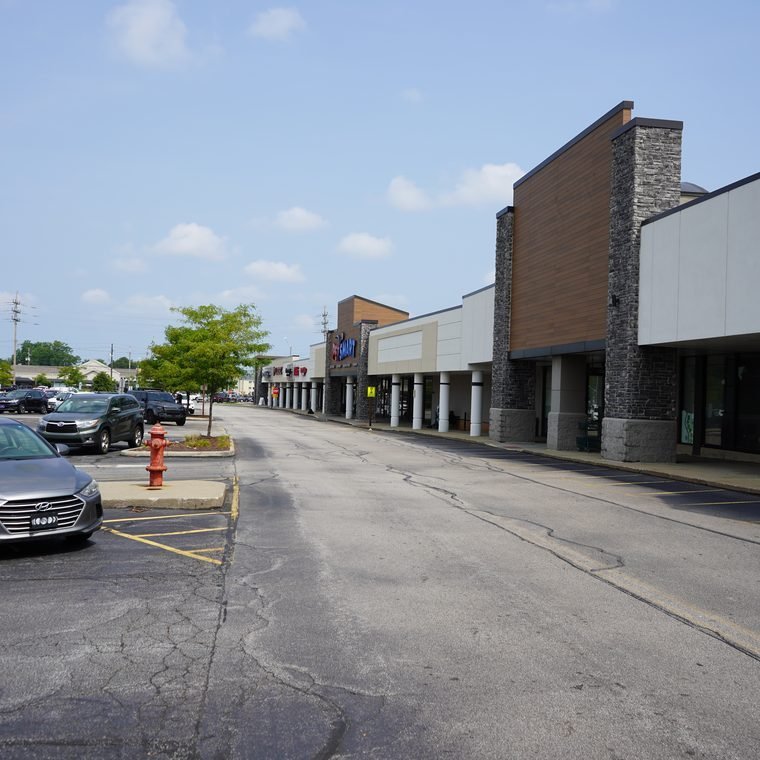 A Mayfield Heights retail strip with storefronts and parking